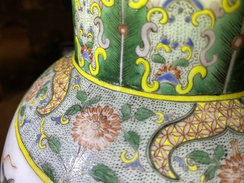 A pair of Chinese famille verte vases and covers with warrior scenes, 19th C.